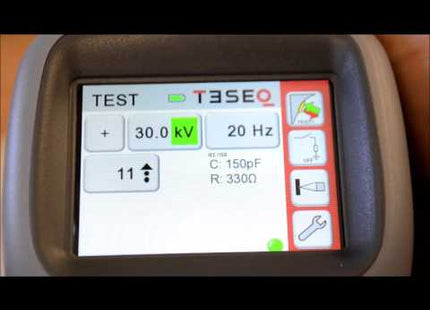 Close-up of Teseq NSG 438 30kV ESD Simulator Gun digital display showing voltage and resistance settings for precise ESD testing control.